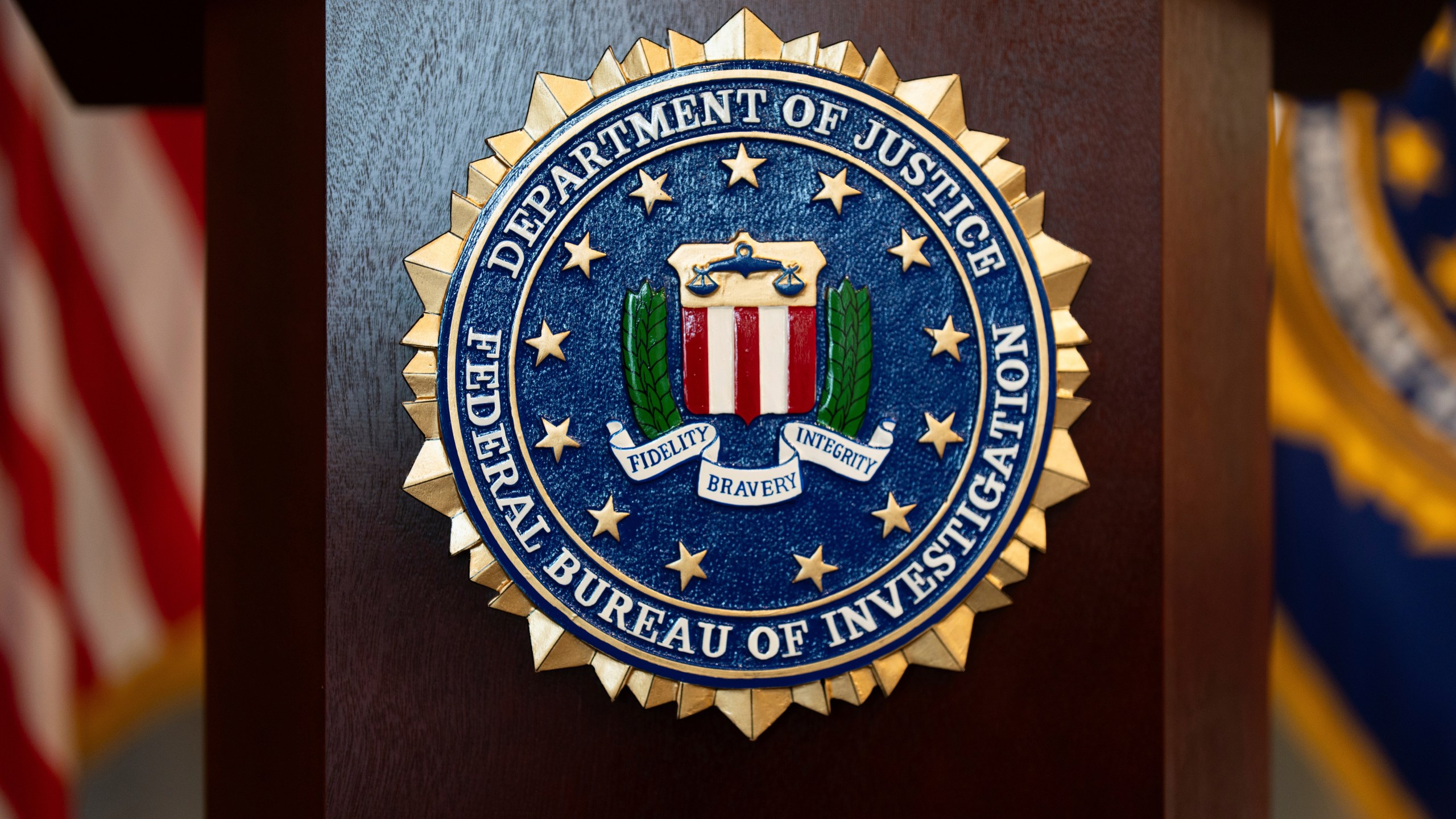 FILE - An FBI seal is displayed on a podium before a news conference at the field office in Portland, Ore., Jan. 16, 2025. (AP Photo/Jenny Kane, File)