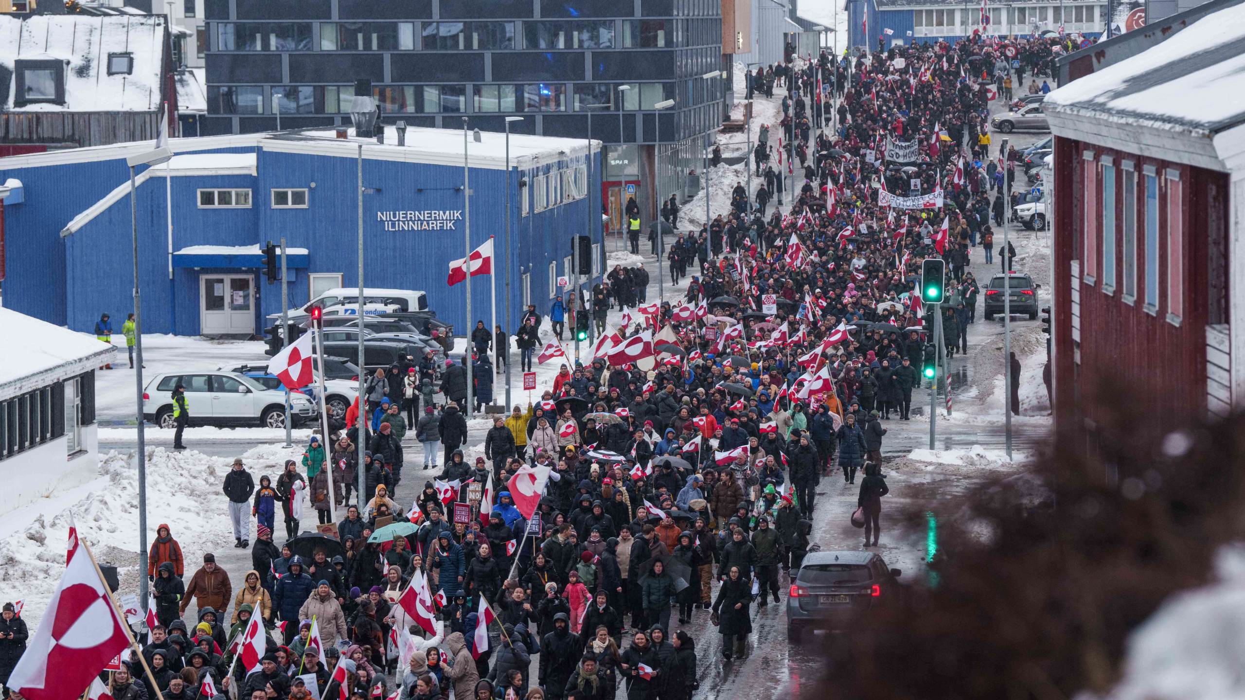 A crowd walks to the US consulate to protest against Trump's policy towards Greenland in Nuuk, Greenland, Saturday, Jan. 17, 2026. (AP Photo/Evgeniy Maloletka)