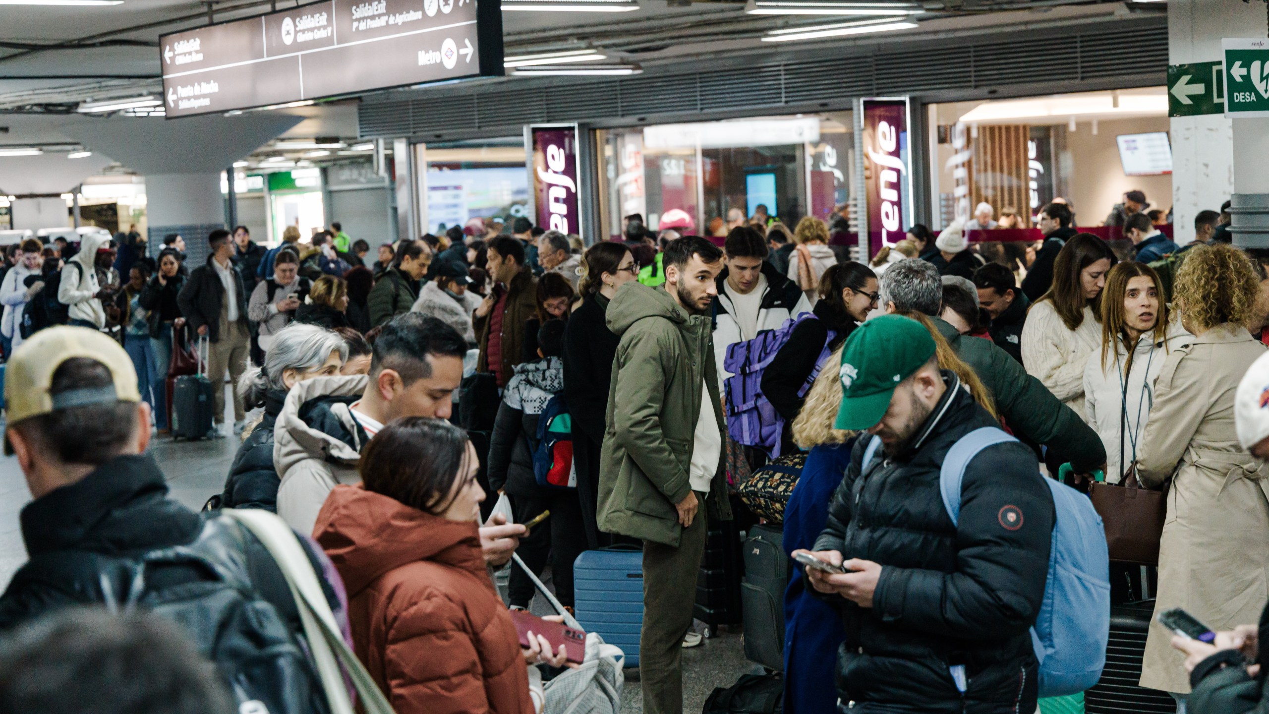Passengers wait in the hall of Madrid train station on Sunday, January 18, 2026, following the announcement of the suspension of service due to an accident in which two trains derailed in Cordoba. ( Carlos Luján/Europa Press via AP)