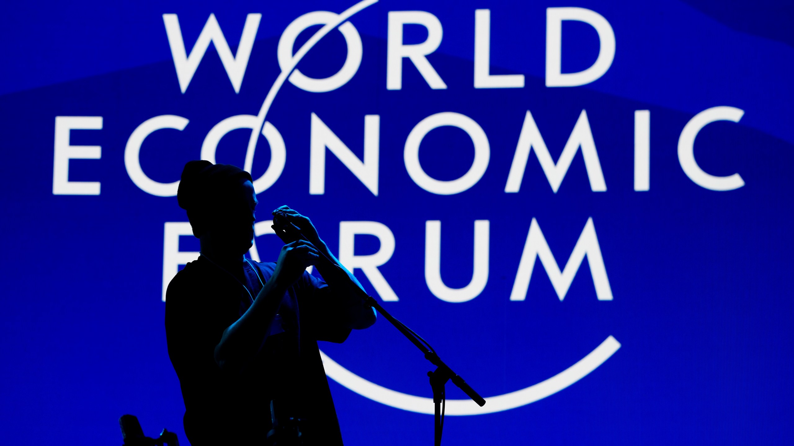 A man installs a microphone for the opening concert of the Annnual Meeting of the World Economy Forum at the Congress Center in Davos, Switzerland, Sunday, Jan. 18, 2026. (AP Photo/Markus Schreiber)