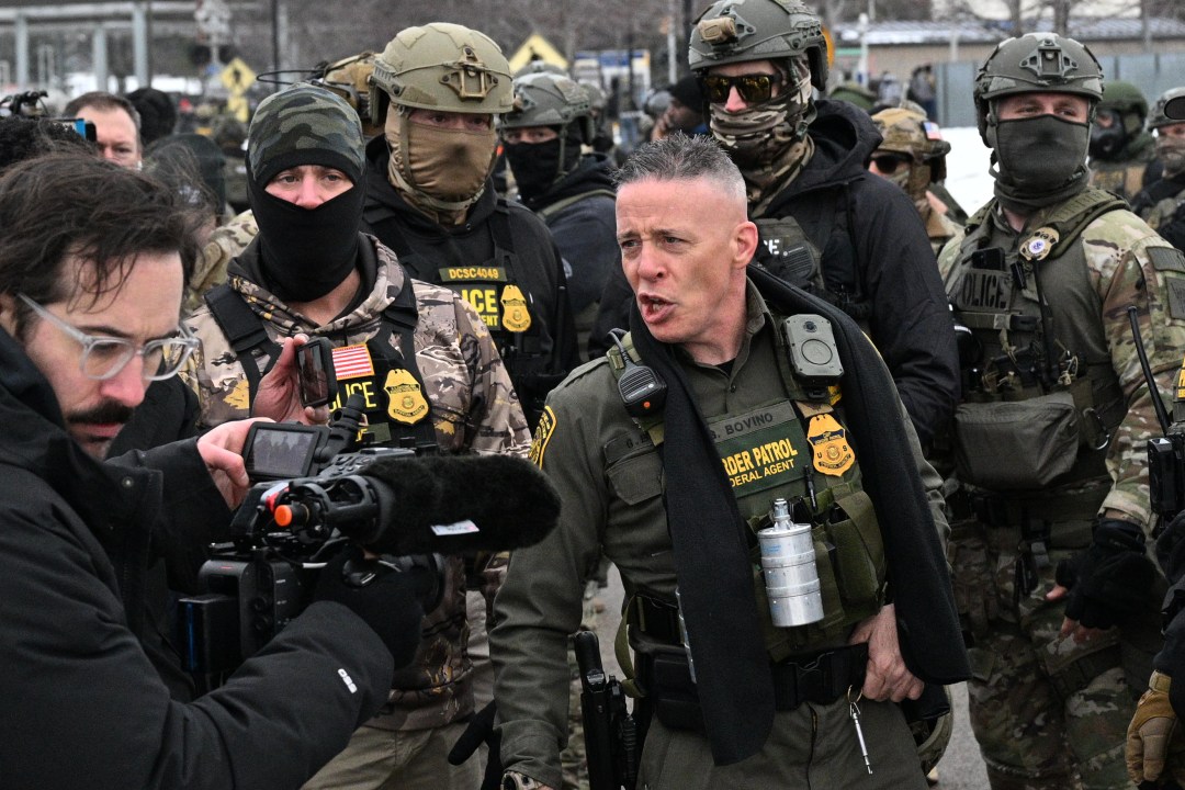 U.S. Border Patrol Cmdr. Gregory Bovino arrives as protesters gather outside the Bishop Henry Whipple Federal Building in Minneapolis, MN.