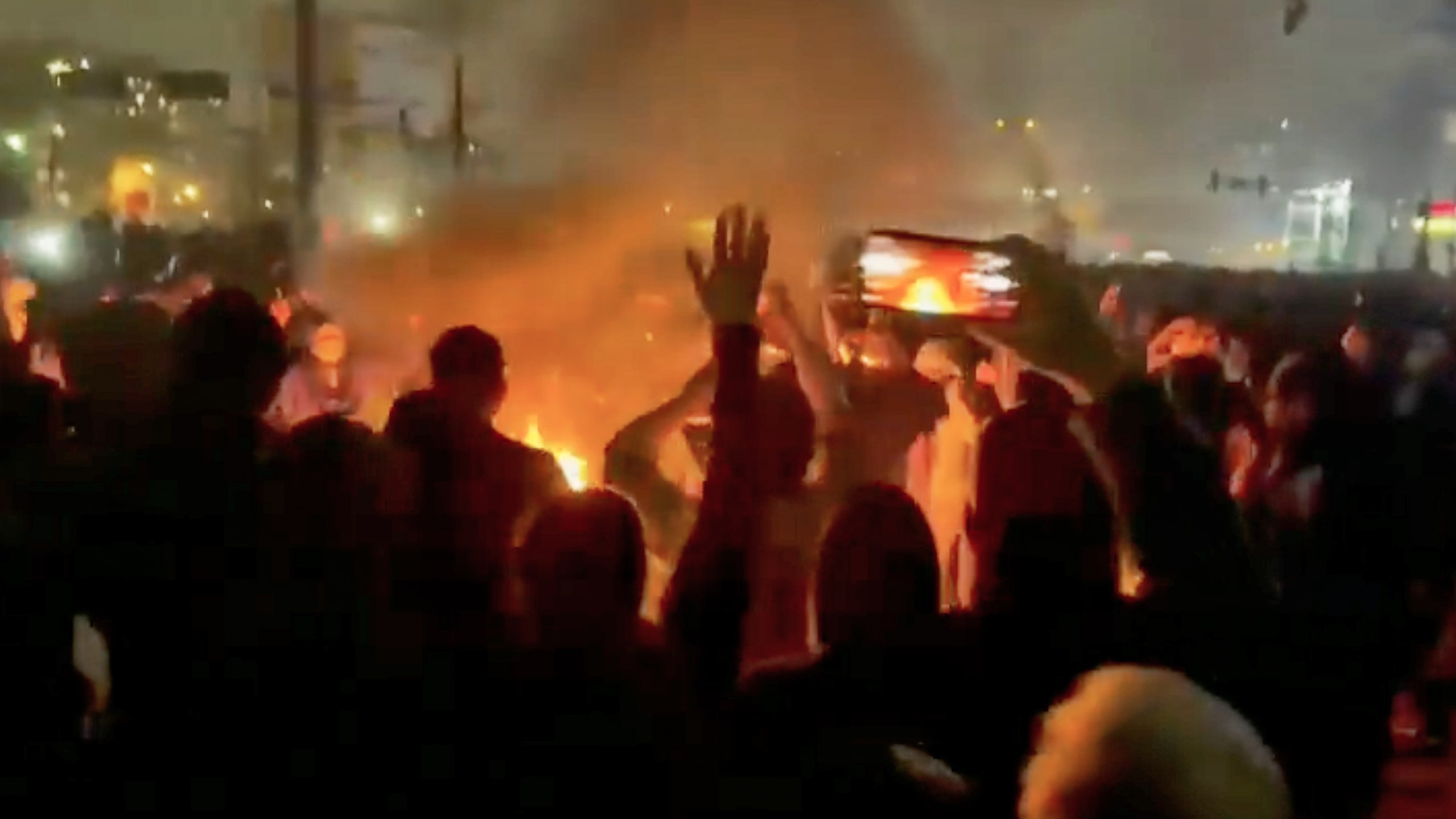 This frame grab from footage circulating on social media shows protesters dancing and cheering around a bonfire in Iran