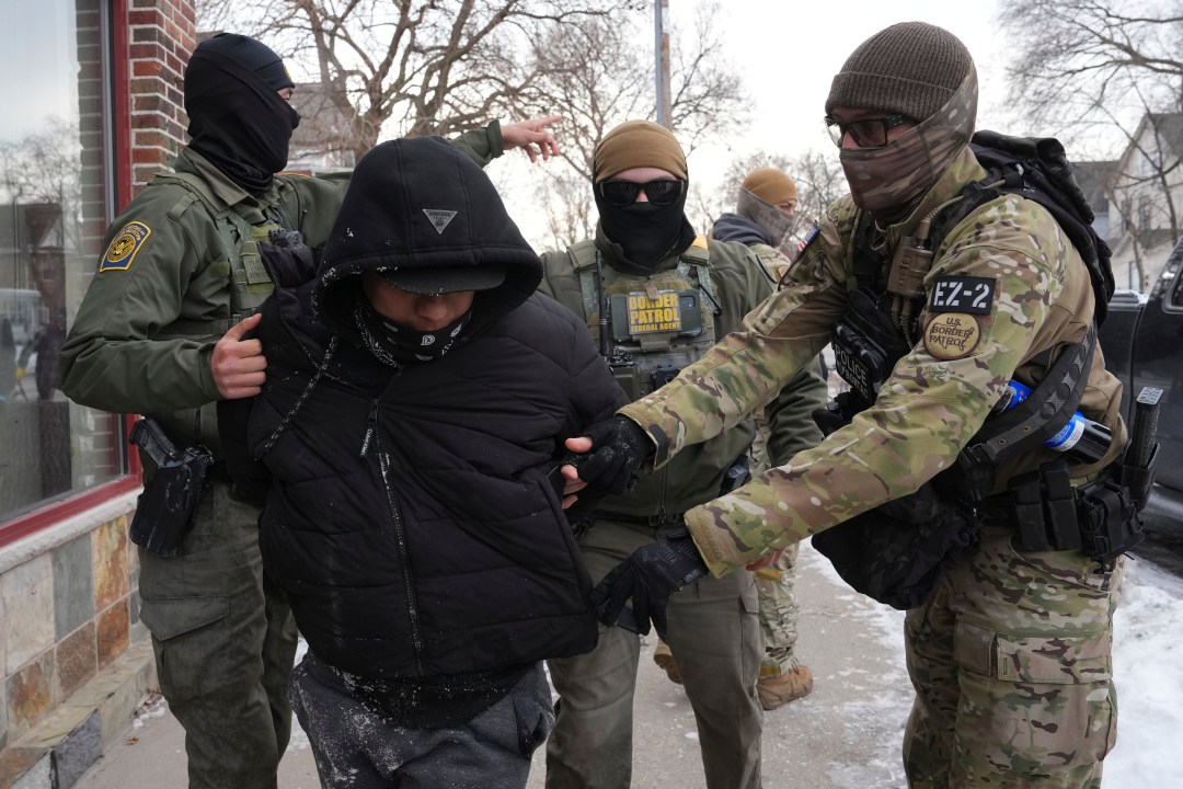 Border Patrol agents detain a man.