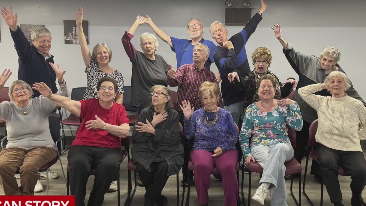 "My American Story" subject Stanley and his students pose for a photo