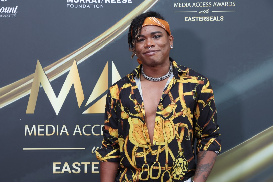 Brian King Joseph in front of backdrop