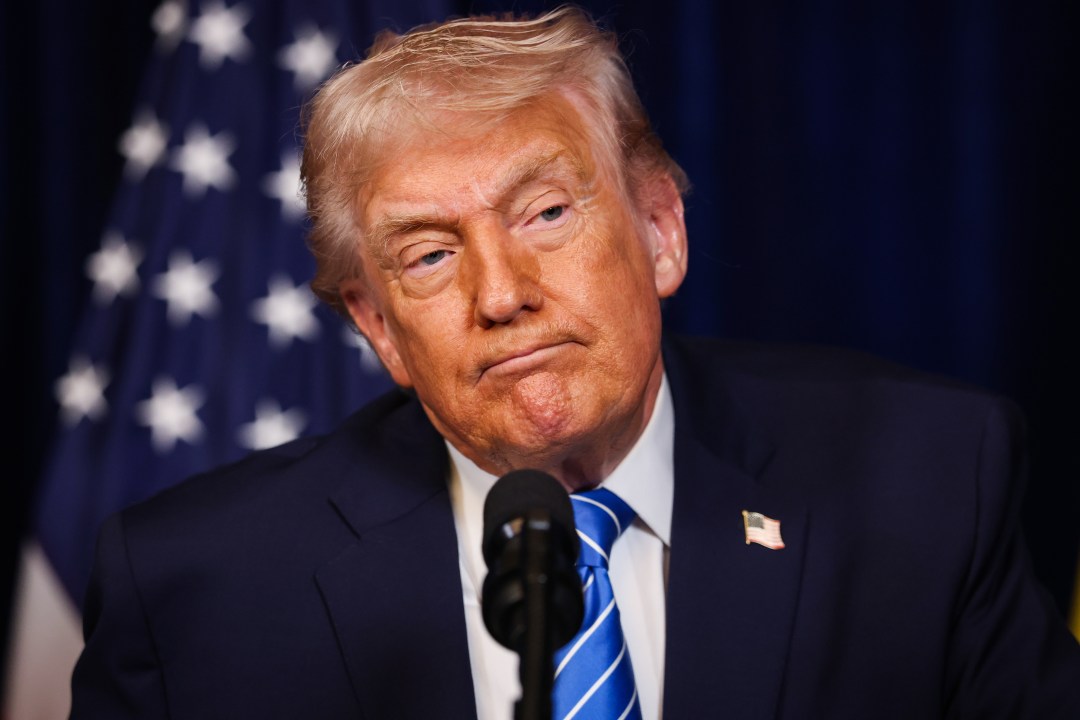 Donald Trump pictured listening during a press conference.