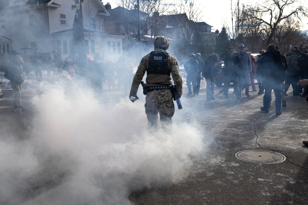 Border Patrol agent walks through tear gas