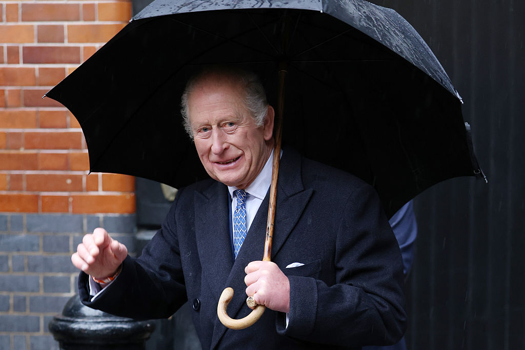 King Charles holding umbrella