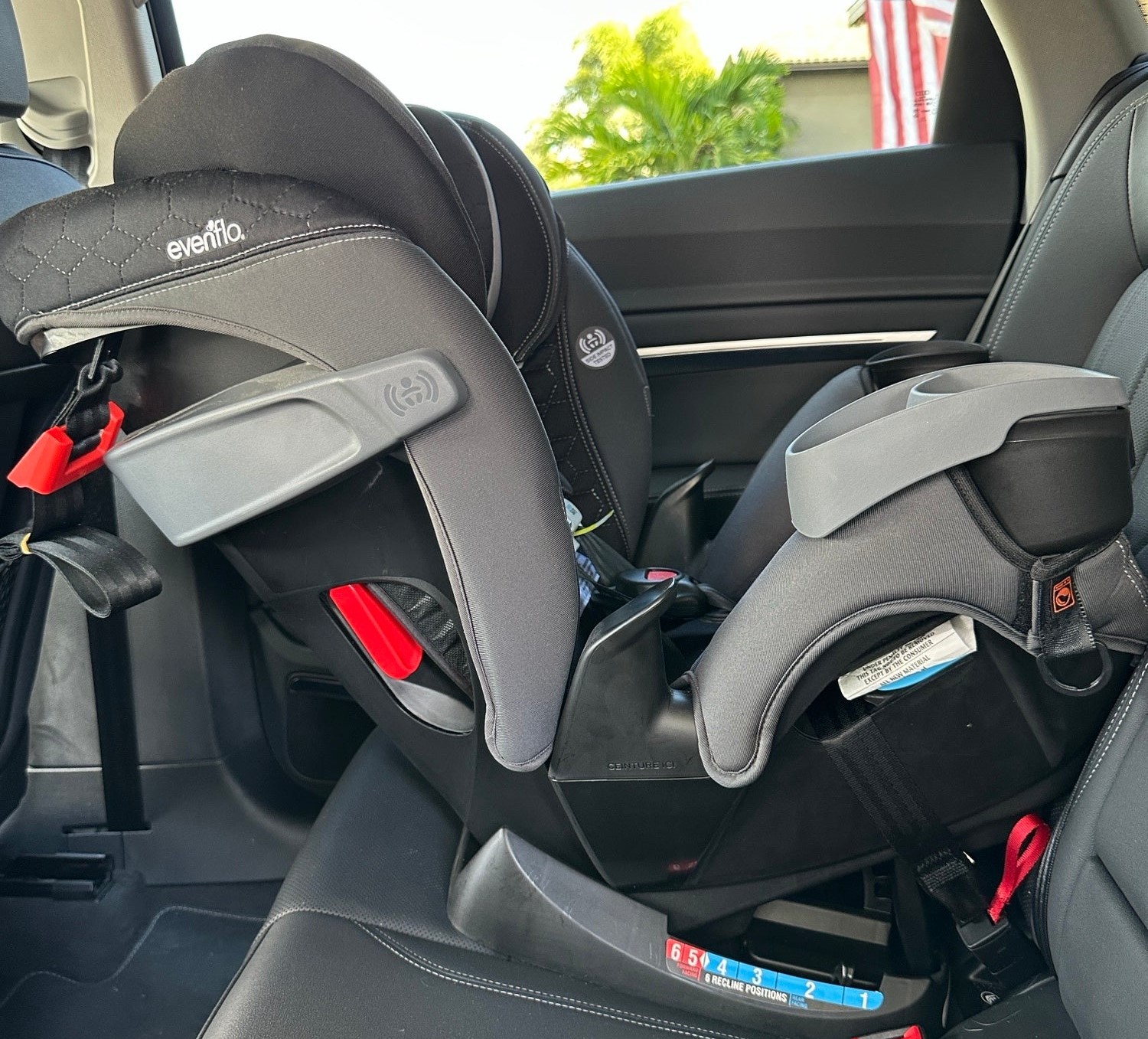 A black and gray car seat inside a car