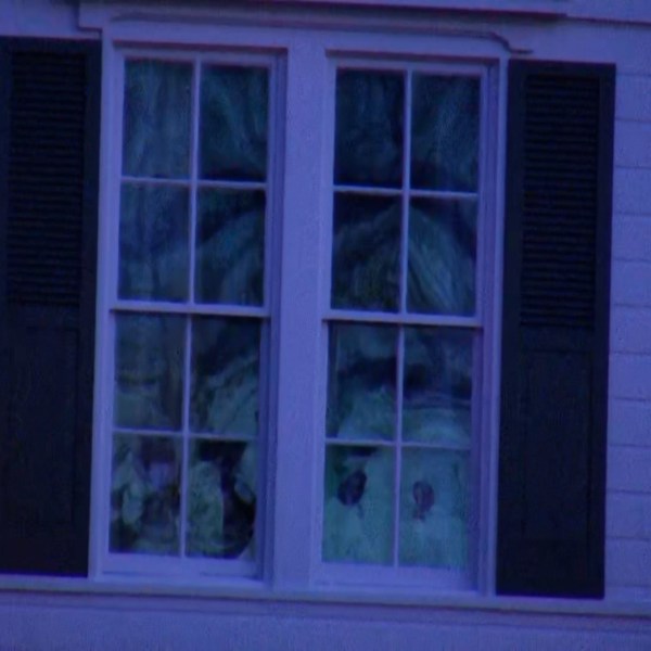 Broken windows on the front of a home